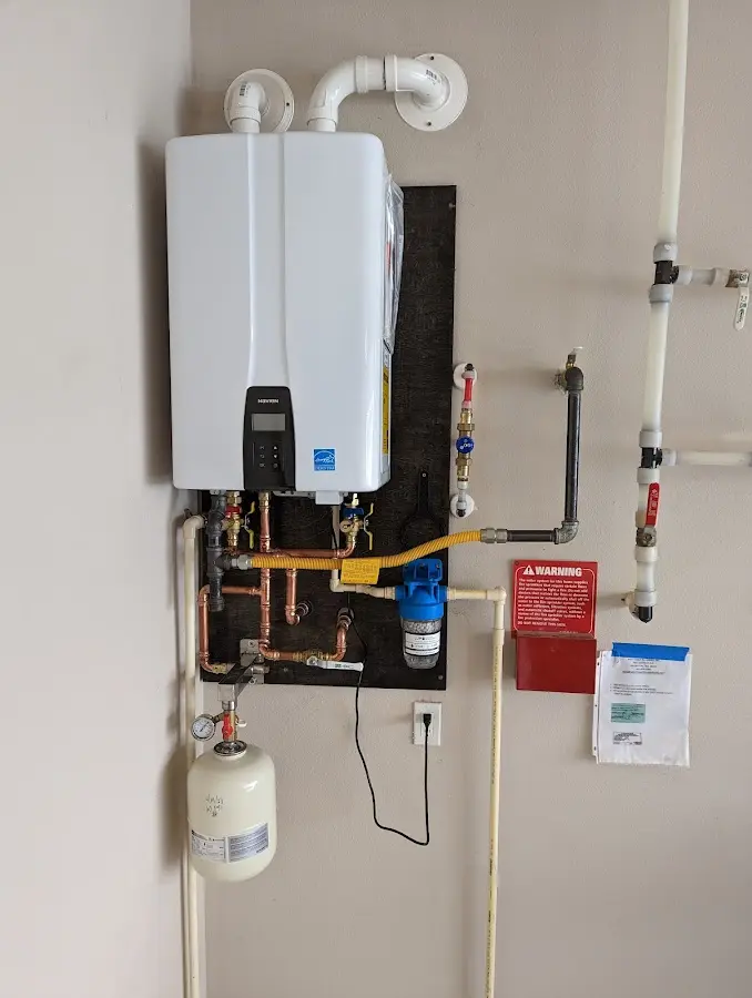 Professional plumber installing copper piping in a Ontwa home